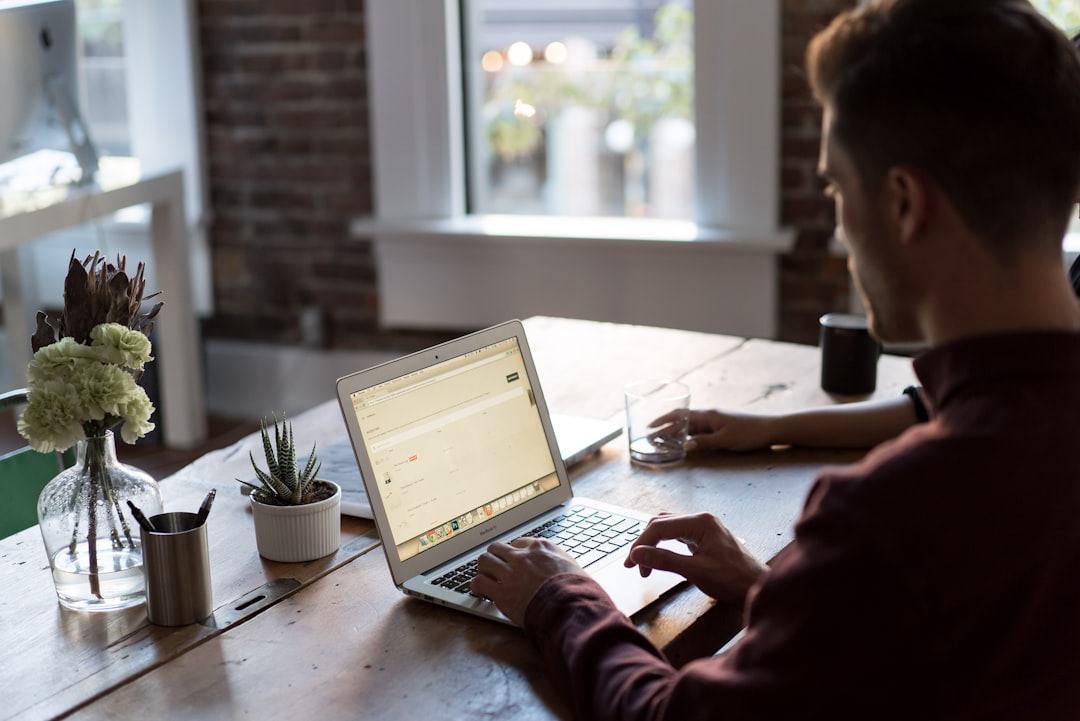 Man at a laptop in an office by Party Plan Checklist man operating laptop on top of table